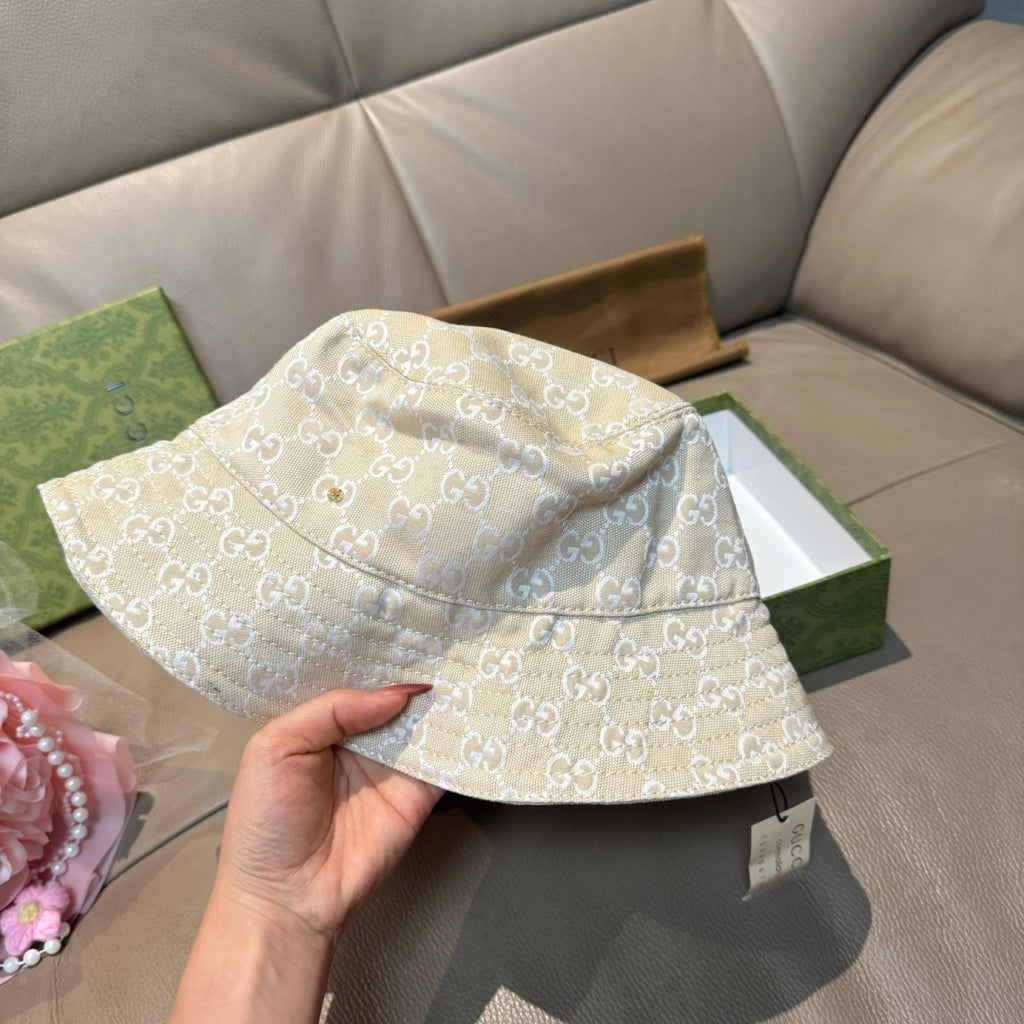 Gucci bucket hat beige/cream GG monogram, front-left view held by hand