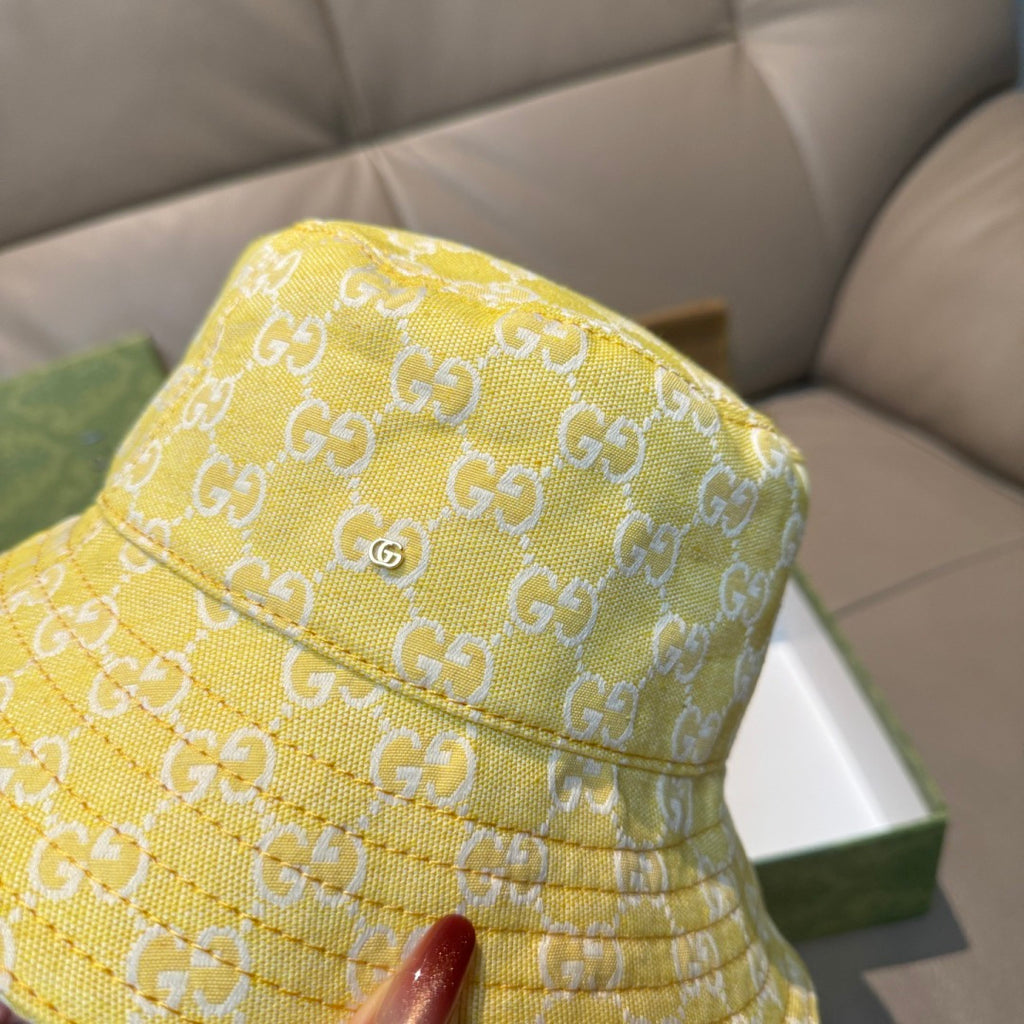 Gucci yellow monogram bucket hat close-up, textured fabric and stitched brim