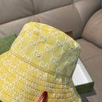 Gucci yellow monogram bucket hat close-up, textured fabric and stitched brim