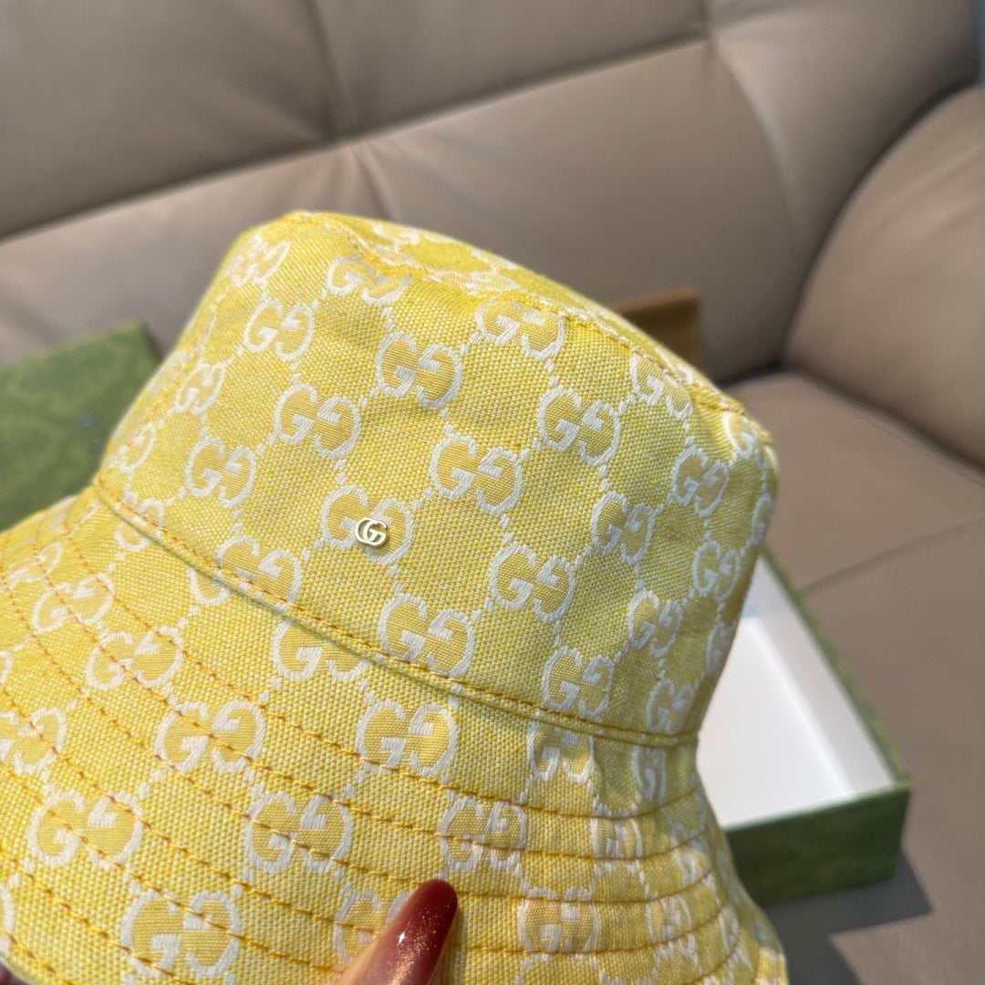Gucci yellow monogram bucket hat close-up, textured fabric and stitched brim