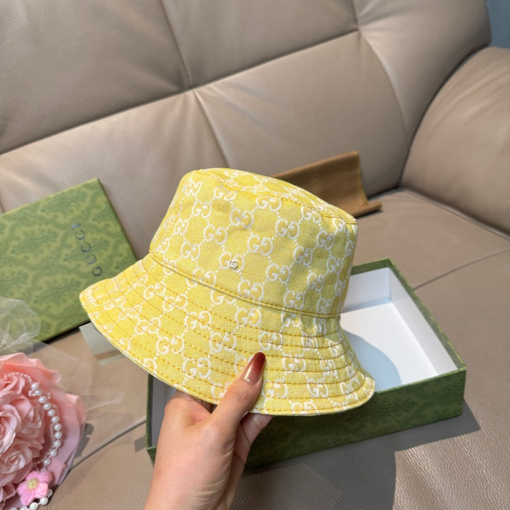 Gucci yellow monogram bucket hat, side view with stitched brim and panels