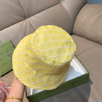 Gucci yellow monogram bucket hat, top view with curved crown and stitched brim