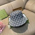 Gucci bucket cap with dark gray GG monogram pattern and wide brim