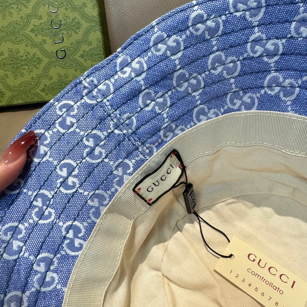Gucci blue bucket hat brim close-up with GG monogram texture and inner label