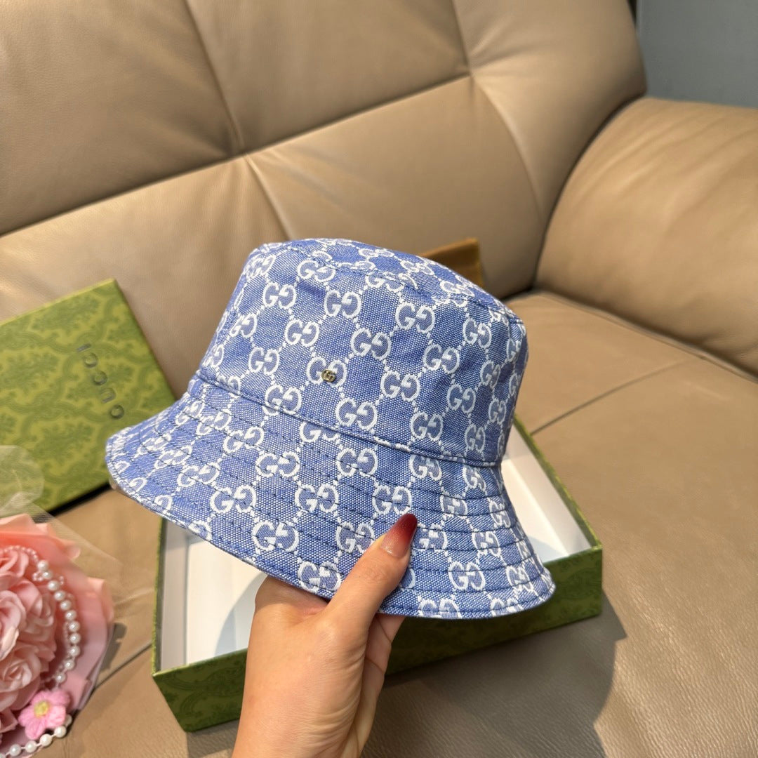 Gucci blue denim-style bucket hat with GG monogram pattern and curved stitched brim