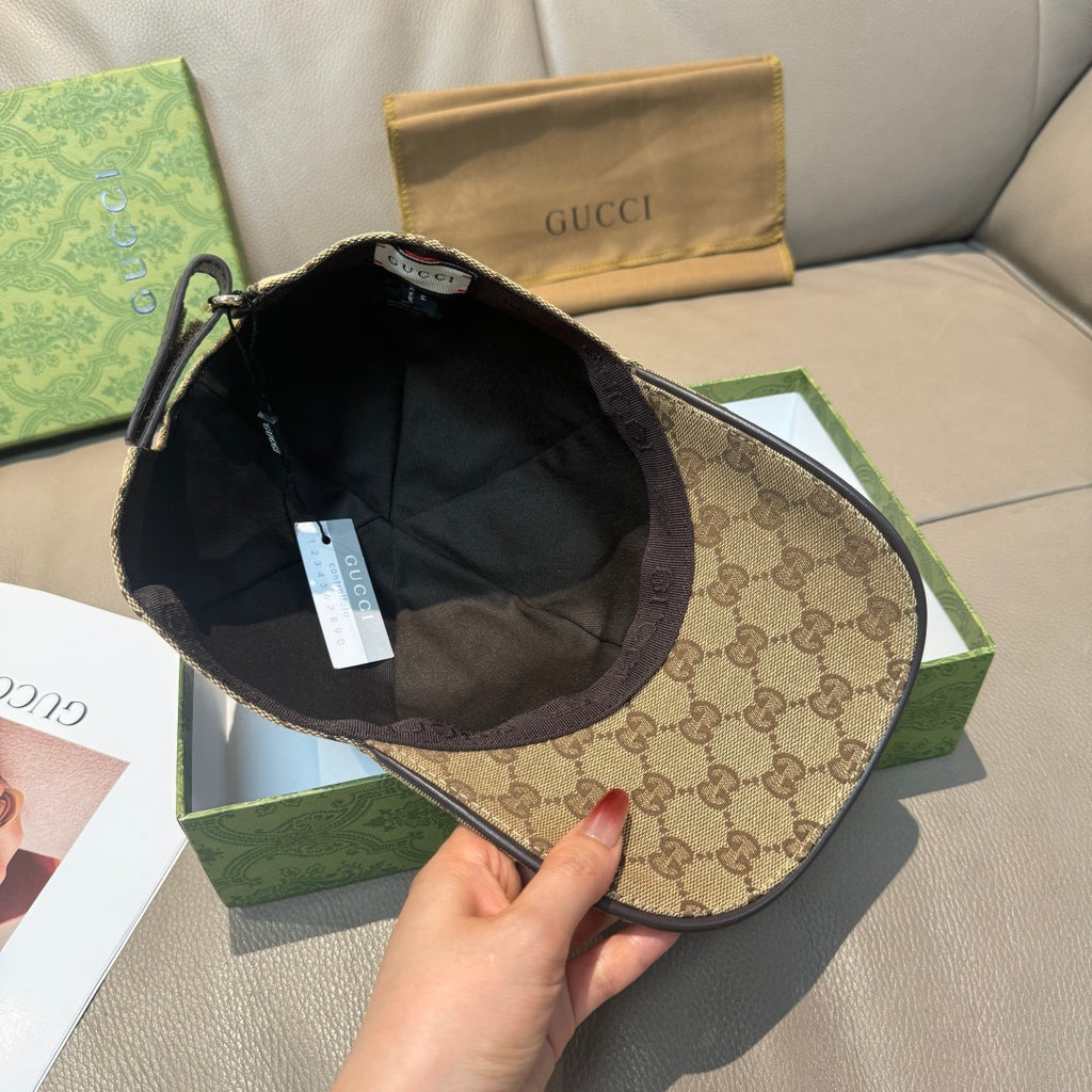 Gucci baseball cap held open, showing dark interior lining and inner seam.