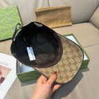 Gucci baseball cap held open, showing dark interior lining and inner seam.