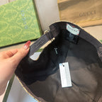 Gucci baseball cap interior view with black adjustable strap and hanging tag.