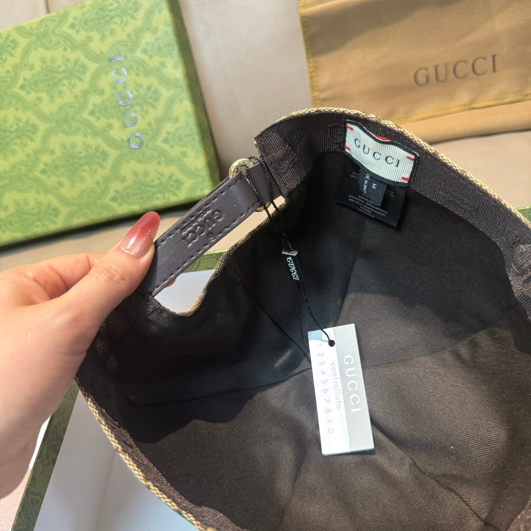 Gucci baseball cap interior view with black adjustable strap and hanging tag.