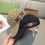 Pair of Gucci baseball caps: beige GG canvas and black fabric, each with multicolor stripe.