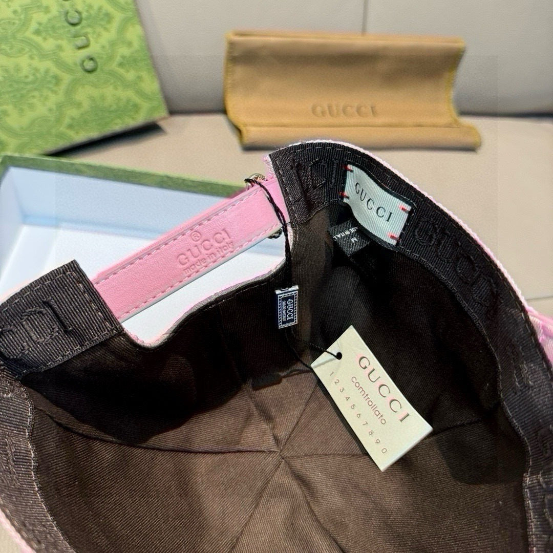Gucci cap interior with black lining, pink edge, and hanging brand tags.