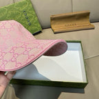 Gucci pink cap with interior lining visible and curved brim edge shown.