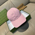 Pink monogram baseball cap with curved brim and embroidered logo detail