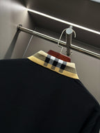 Burberry long-sleeve polo shirt collar close-up, black with check trim