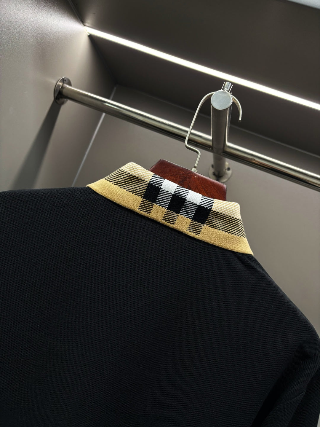 Burberry long-sleeve polo shirt collar close-up, black with check trim