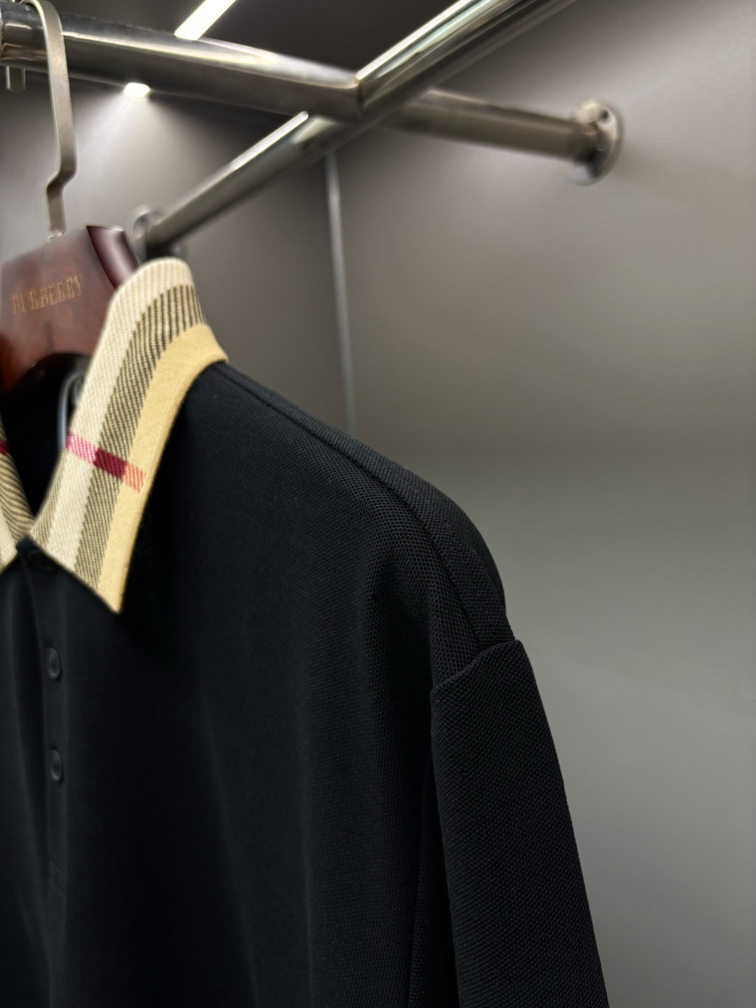 Burberry long-sleeve polo shirt side view, black with check collar