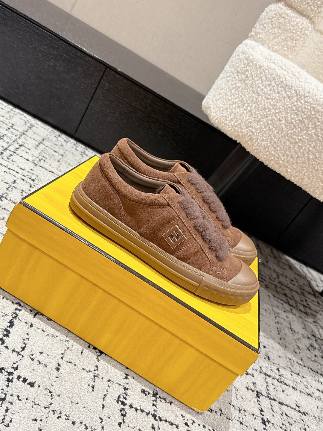 Brown suede Fendi sneakers on a box, side and front view with lace detailing