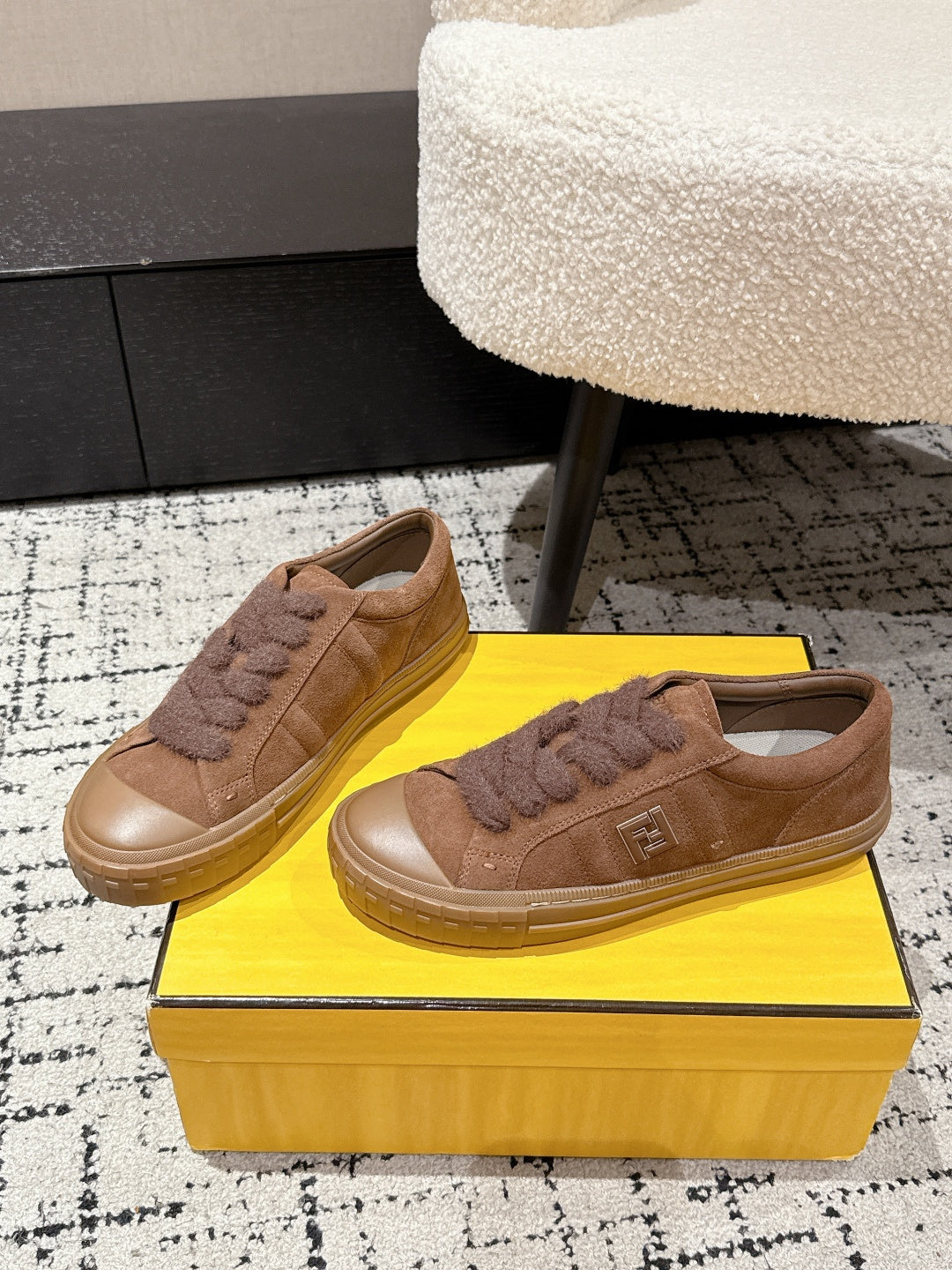Brown suede Fendi sneakers shown side by side, front quarter view