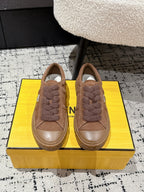 Brown suede Fendi sneakers with plush lace trim, shown as a pair from the front