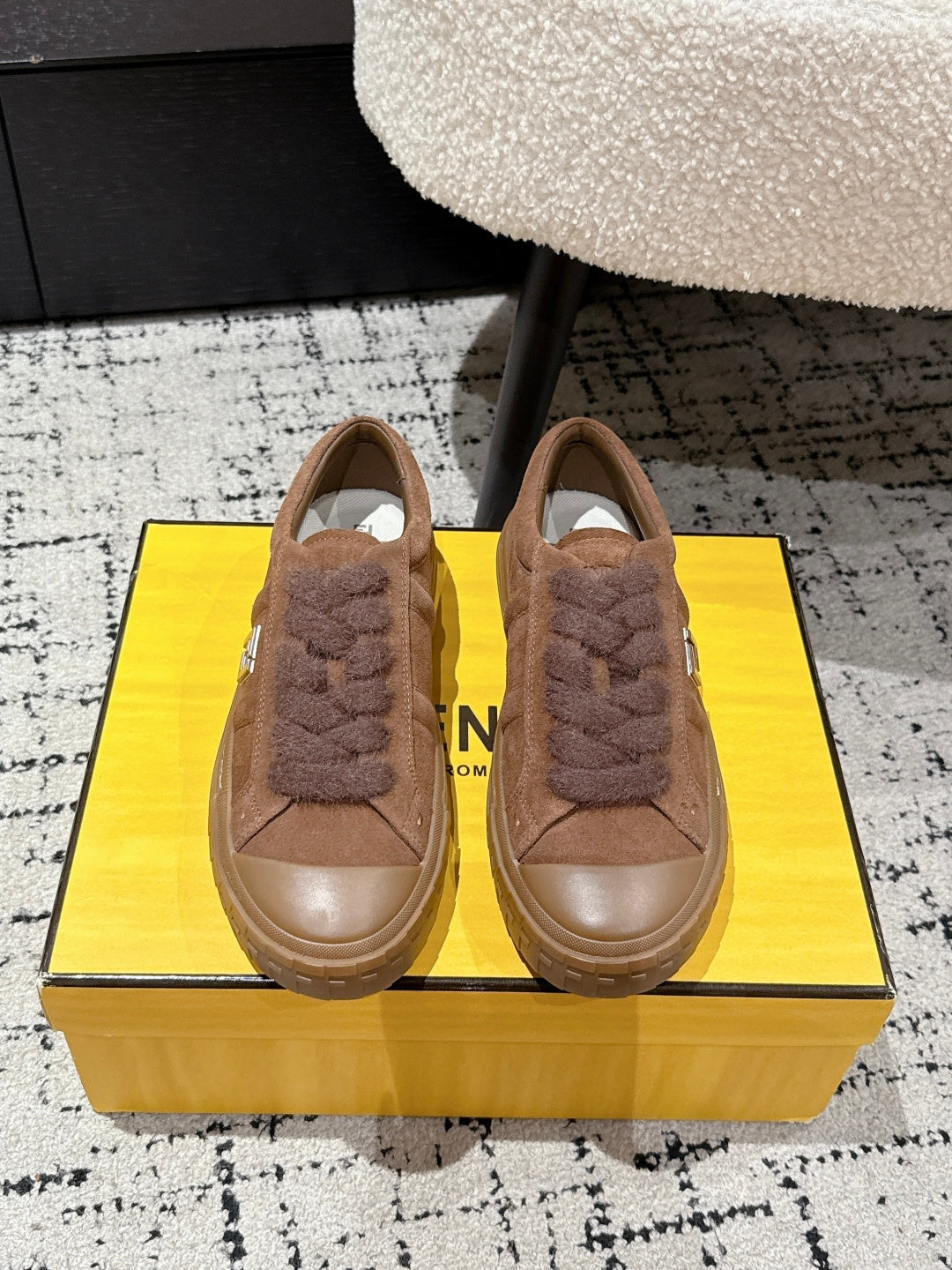 Brown suede Fendi sneakers with plush lace trim, shown as a pair from the front