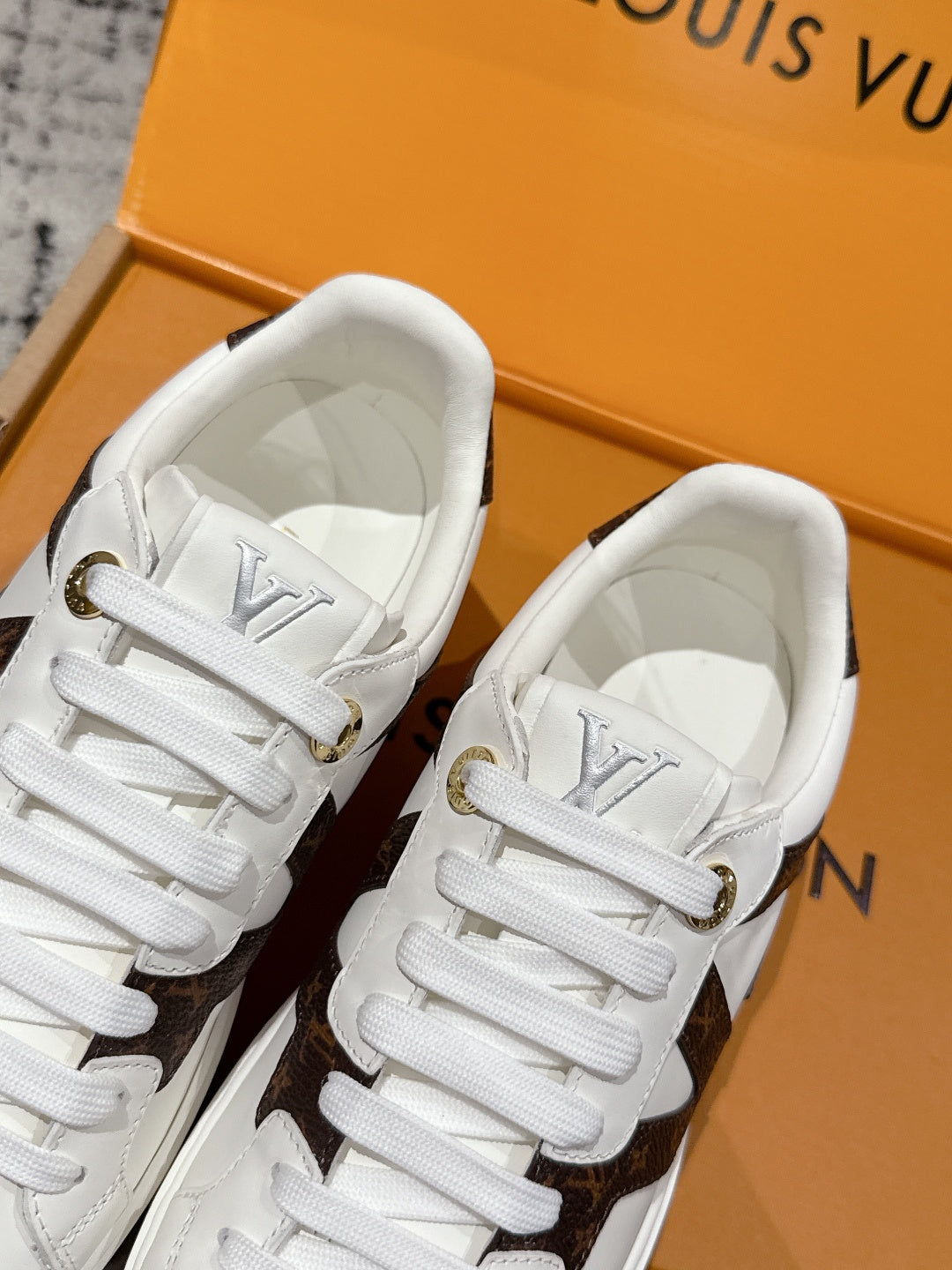 White sneaker tongues with lace-up eyelets and white fabric lining