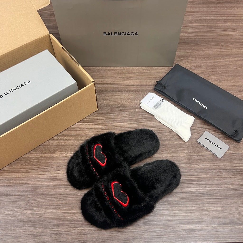 Black plush slide sandals with red logo outline, crossed straps