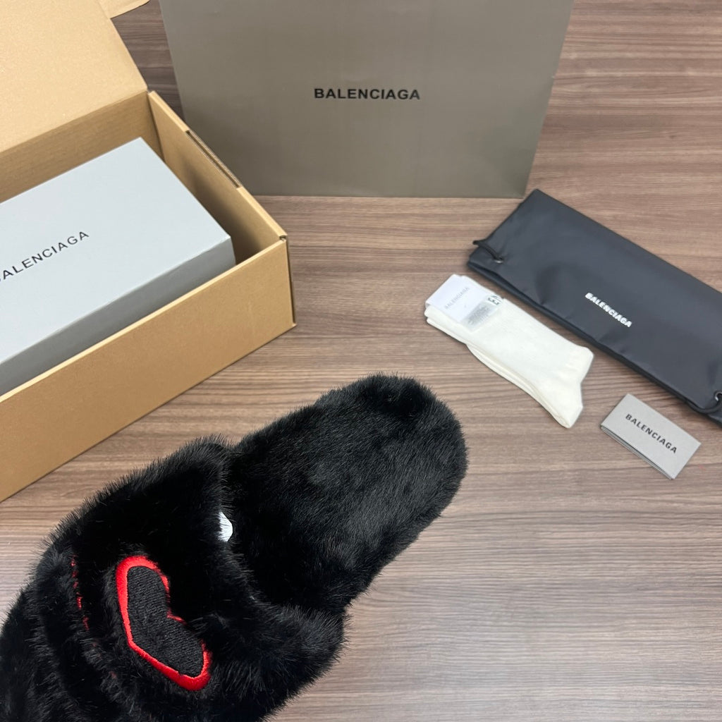 Black plush slide sandals with red logo detail, open-toe view