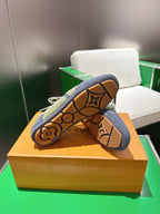 Unisex sneaker outsole with brown monogram-style tread pattern and lace-up upper