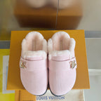 Pink plush slide sandals with gold V logo on front strap and dark rubber edge