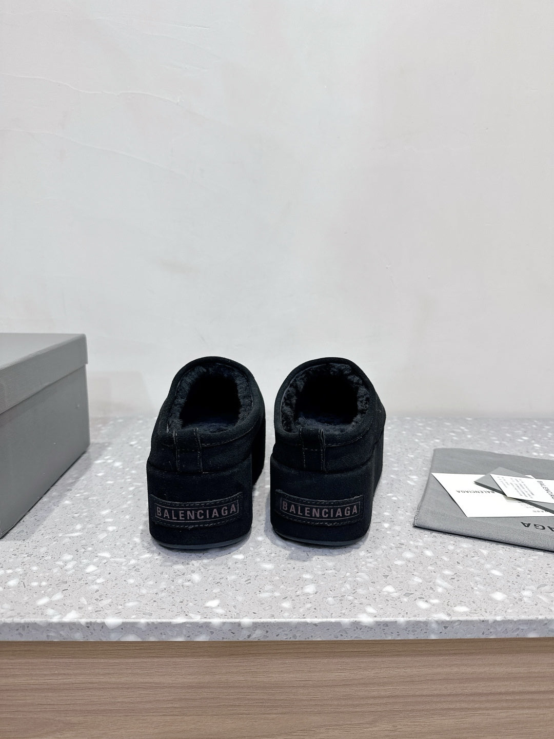 Balenciaga suede slip-on sandals in dark navy, heel view with Balenciaga logo