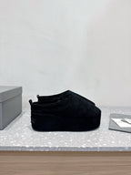 Balenciaga suede slip-on sandals in dark navy, side profile on display