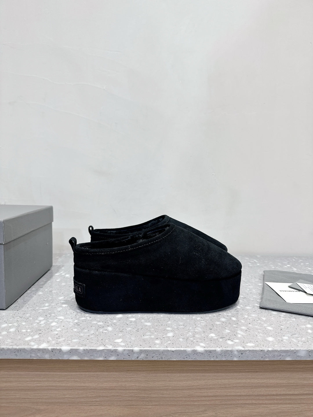 Balenciaga suede slip-on sandals in dark navy, side profile on display