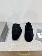 Balenciaga suede slip-on sandals in dark navy, side view pair on display