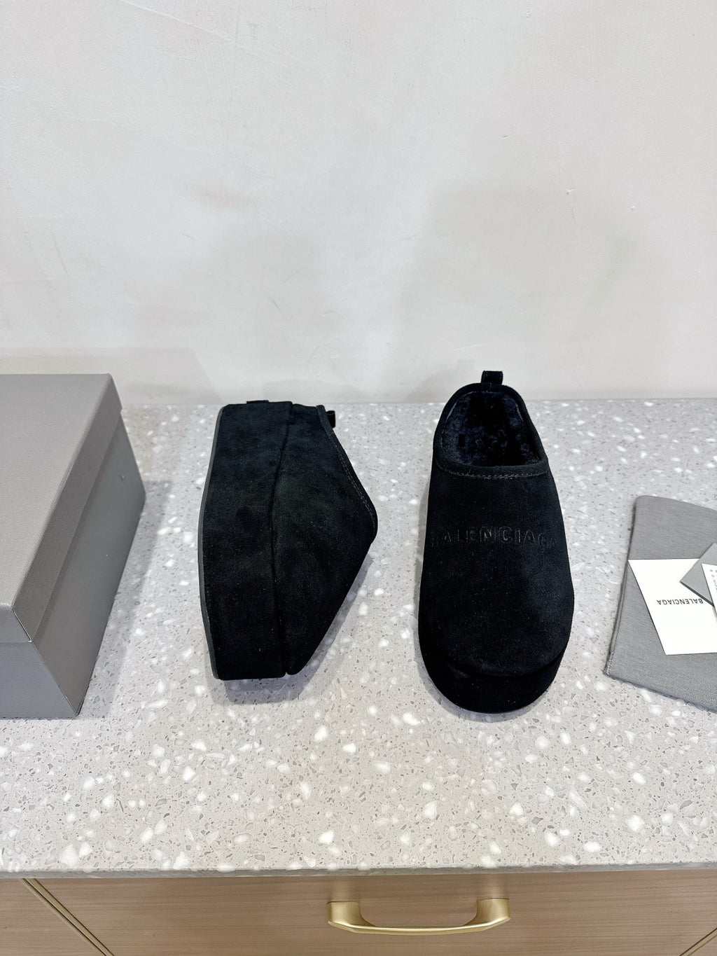 Dark blue suede slip-on sandals, showing side profile