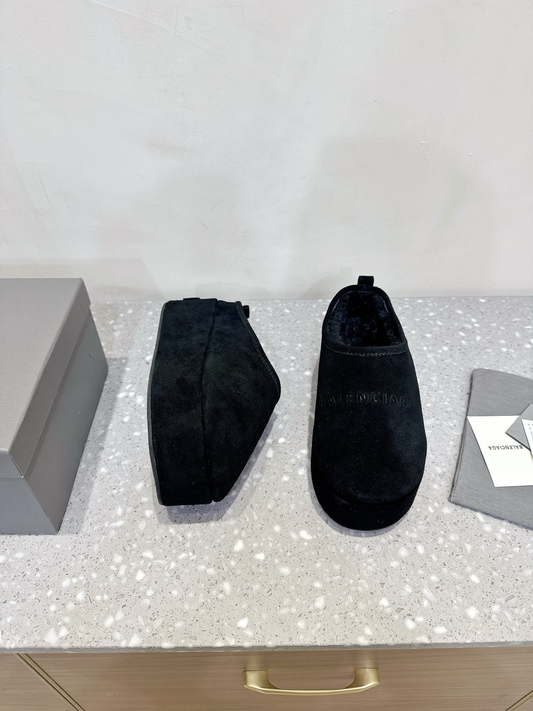 Dark blue suede slip-on sandals, showing side profile