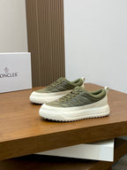 Olive low-top sneakers on display with white rubber midsole and Moncler side branding
