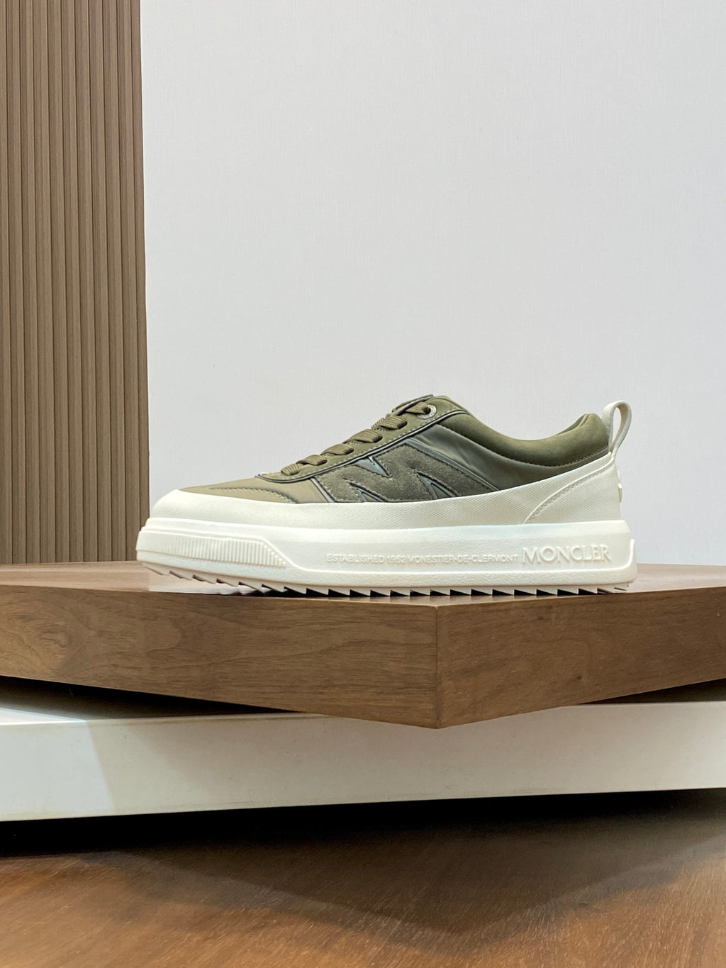 Olive lace-up sneakers with white sole and subtle side logo on low profile upper