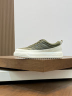 Olive lace-up sneakers with white sole and subtle side logo on low profile upper