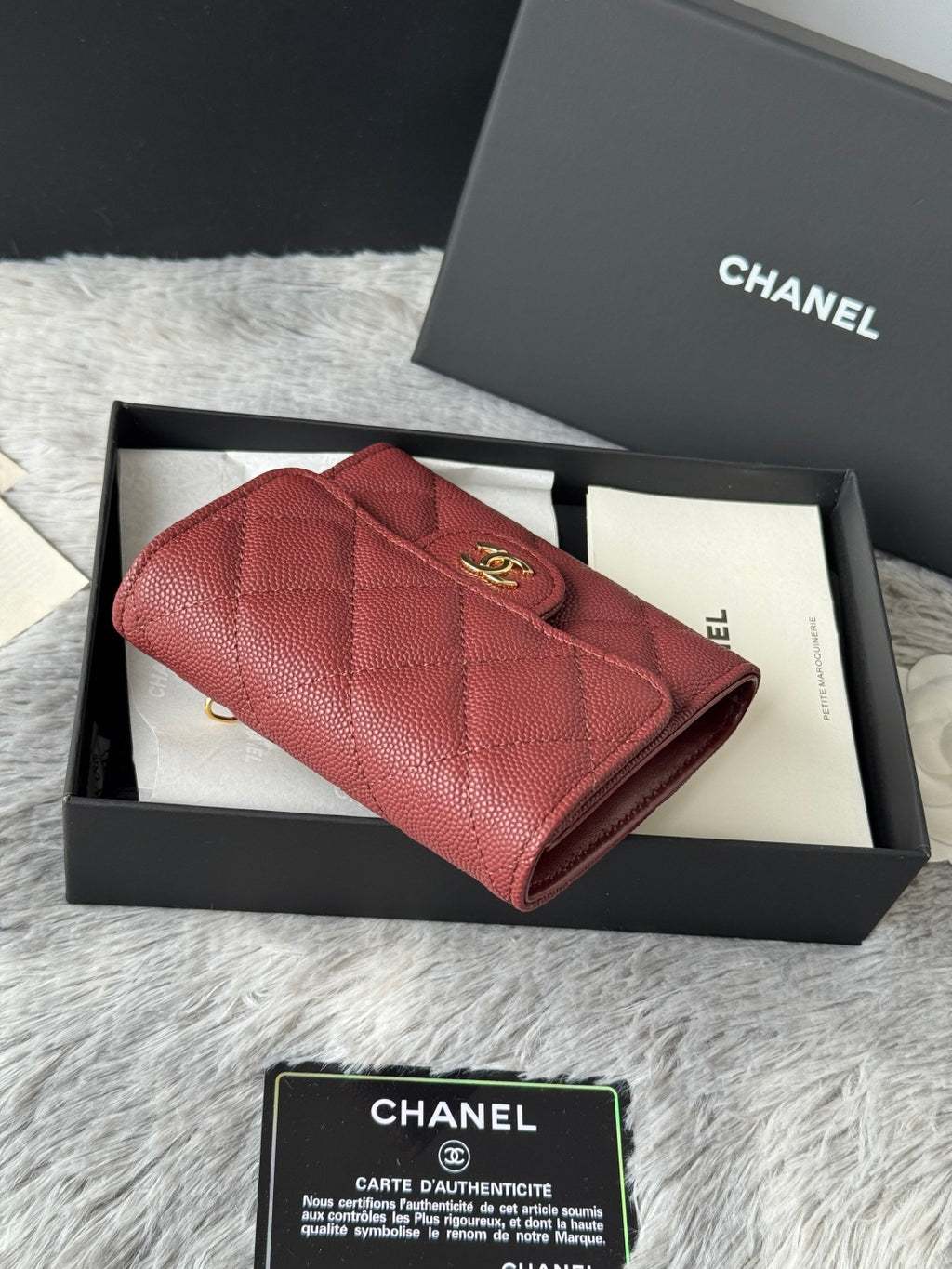 Small quilted red wallet bag with flap closure and gold CC logo