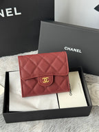 Small quilted red flap wallet bag with gold CC medallion front