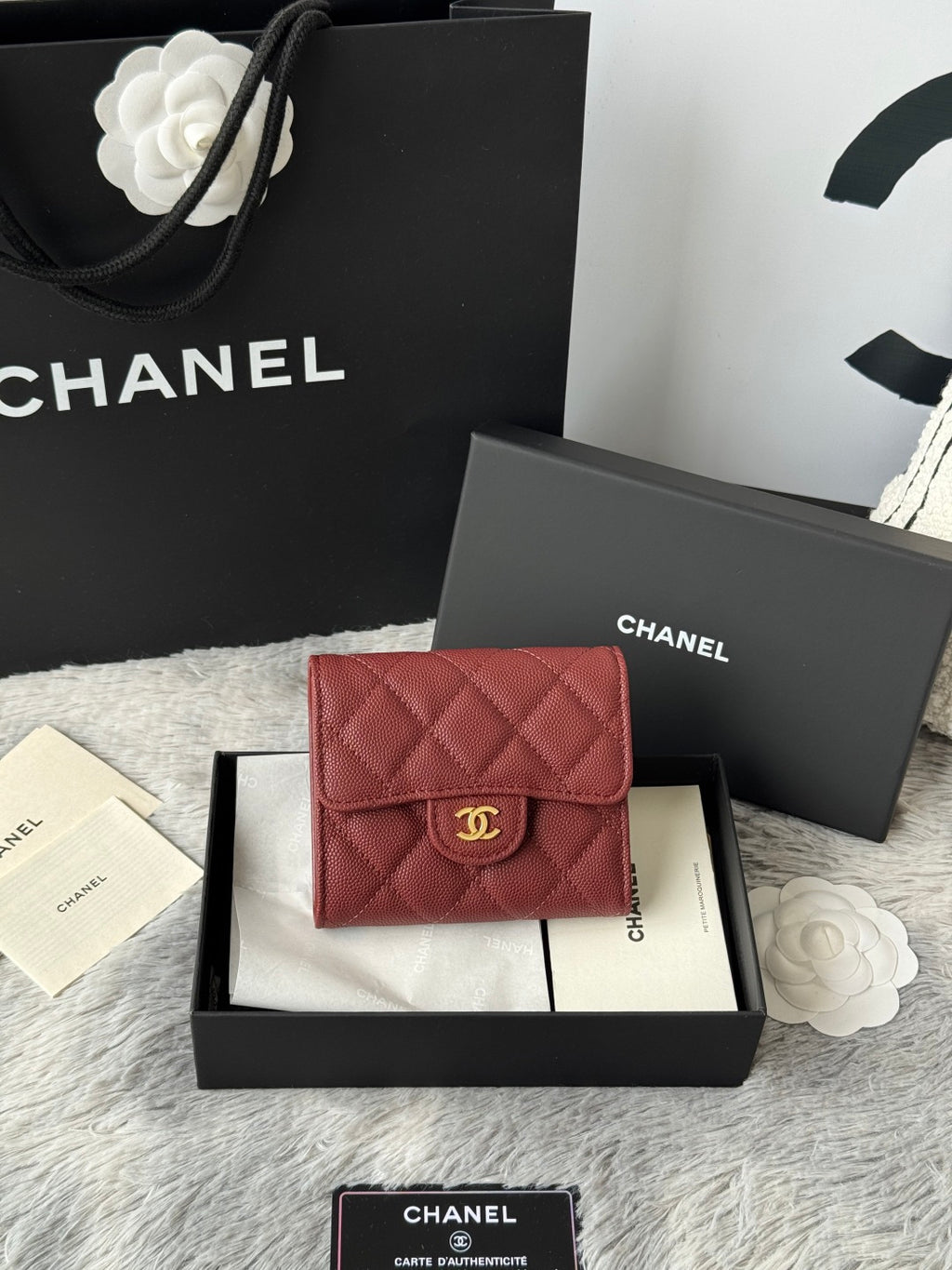 Small quilted red wallet bag with flap closure and gold CC logo