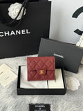Small quilted red wallet bag with flap closure and gold CC logo