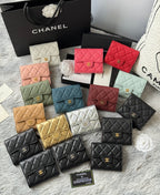 Multiple quilted mini flap bags with gold logo clasp in light, red, and black tones
