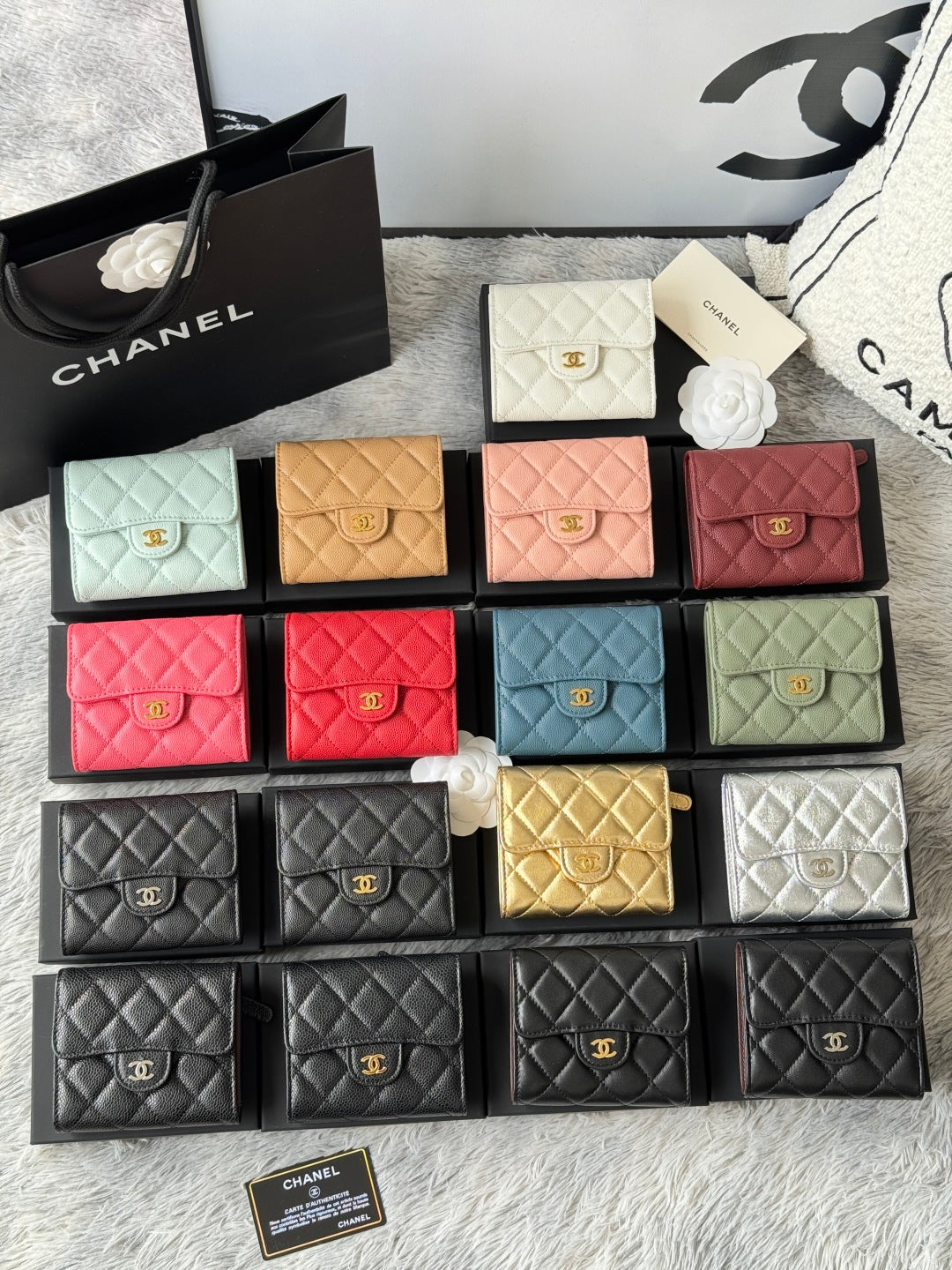 Assorted quilted mini flap bags with gold logo clasp in pink, tan, teal, black