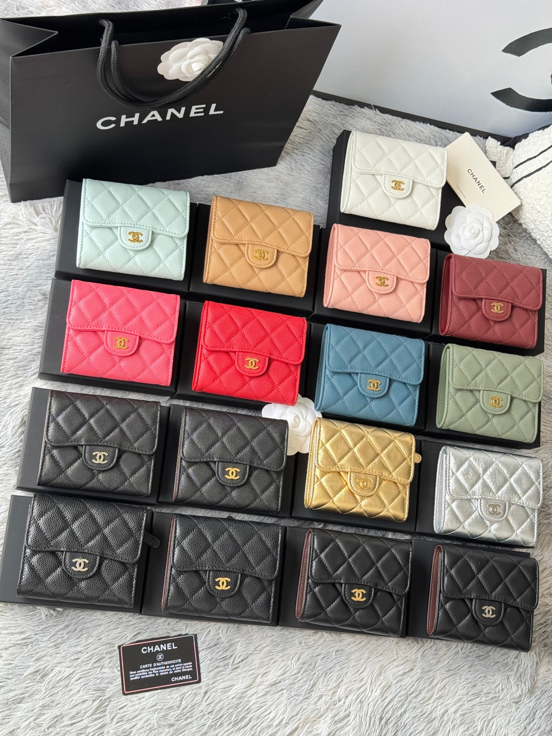 Multiple quilted mini flap bags in mixed colors, each with gold logo clasp