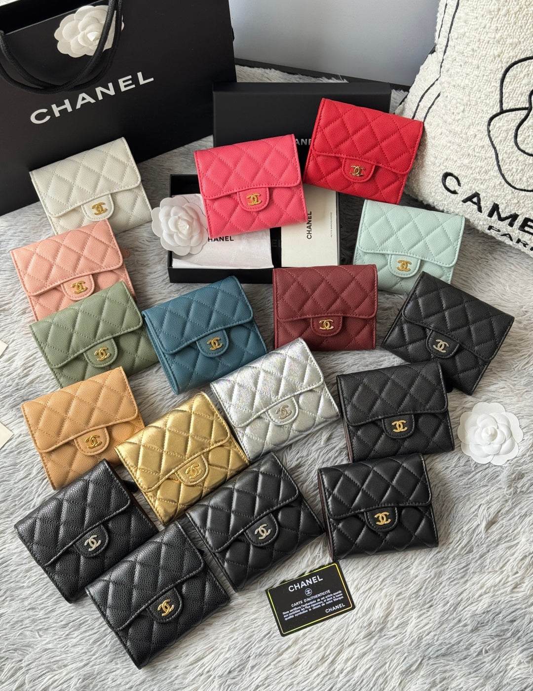 Assorted quilted mini flap bags with gold clasps in pastel, gold, and black