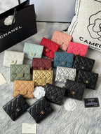 Collection of quilted mini flap bags with gold clasp detail in red, green, and black