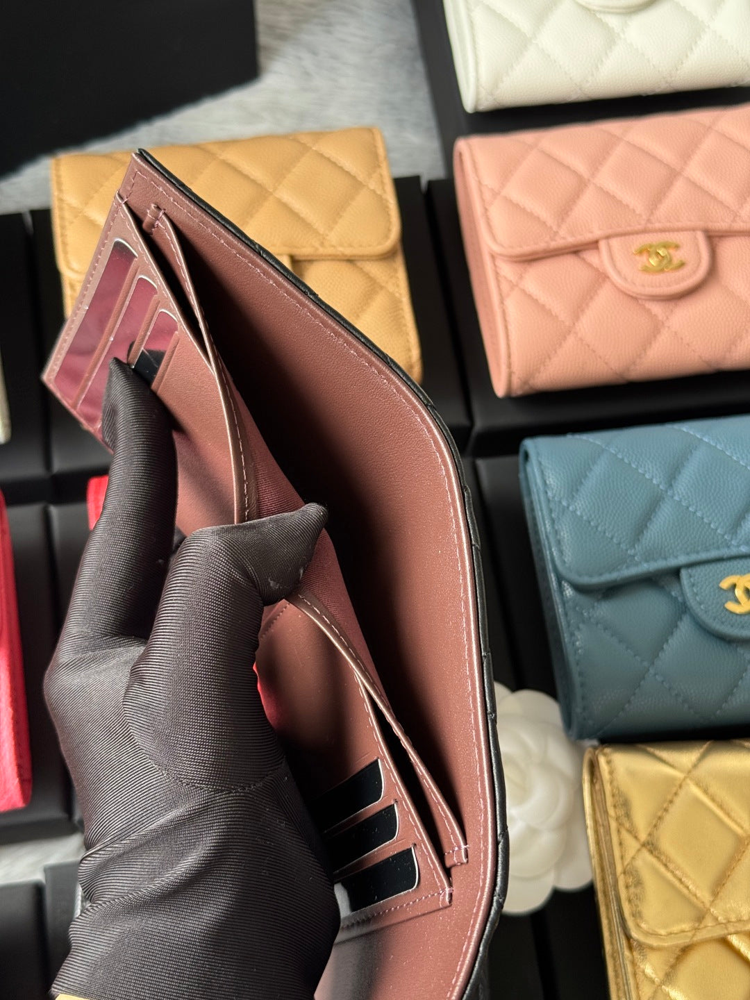 Brown quilted small wallet held upright with visible card slots inside