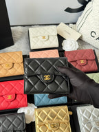 Black quilted small flap bag with gold CC emblem among assorted colors