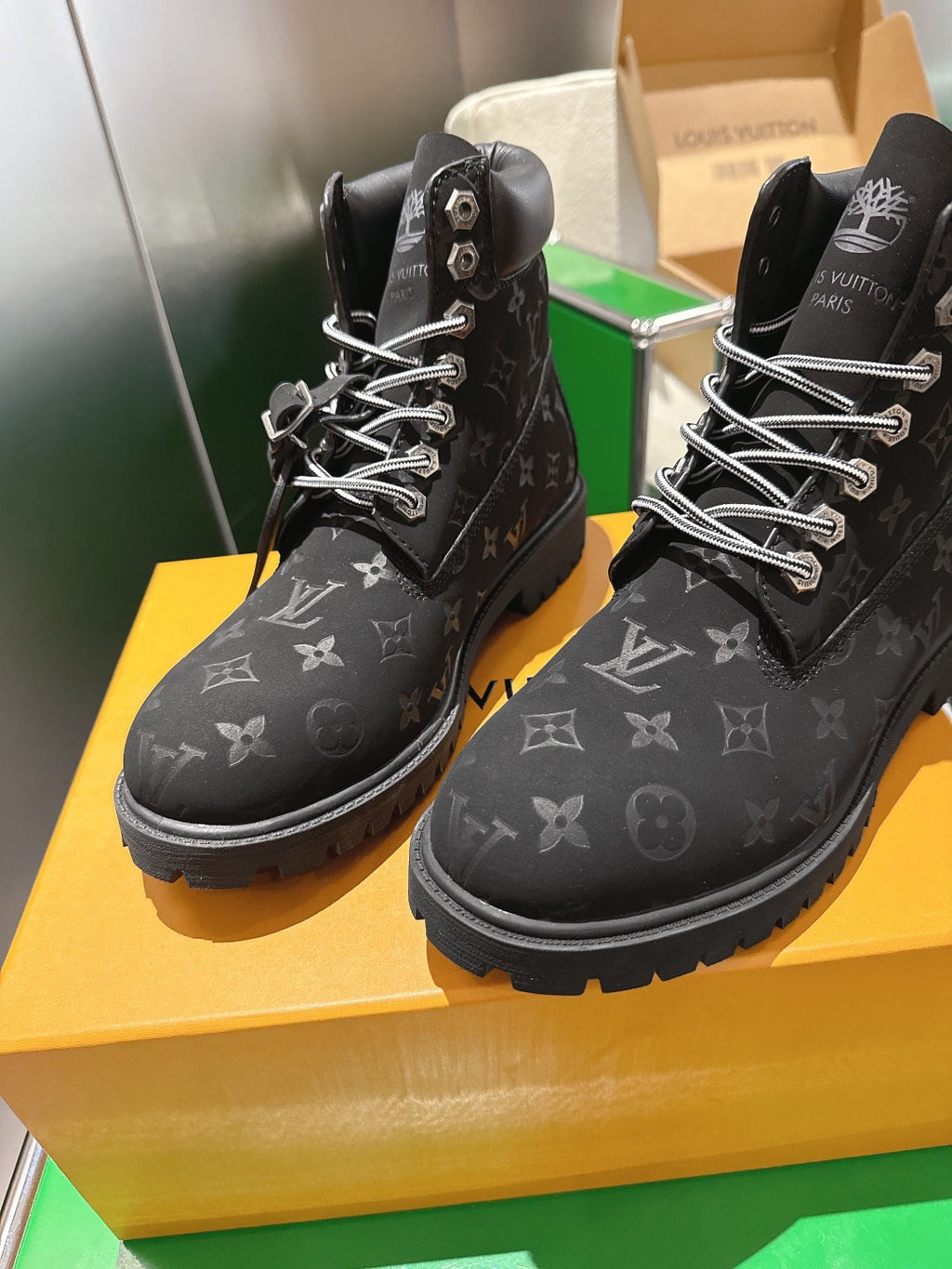 Louis Vuitton monogram lace-up boots, pair view on yellow box with laces